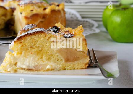 a slice of fresh and homemade apple cake with sour cream filling Stock Photo