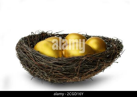 Golden eggs in decorative nest isolated at white background Stock Photo