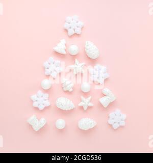 Christmas tree is made from a white toys on pink background. Christmas composition, wallpaper. Flat lay, top view Stock Photo