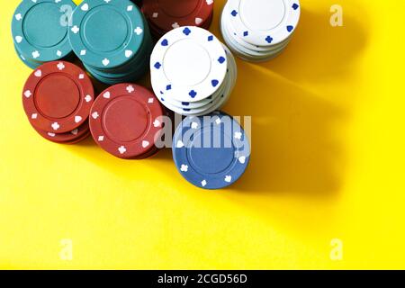 poker chips on yellow background Stock Photo