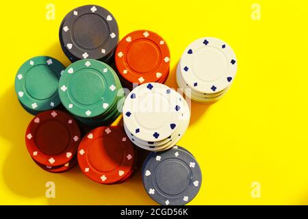 poker chips on yellow background Stock Photo