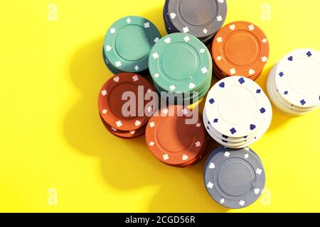 poker chips on yellow background Stock Photo
