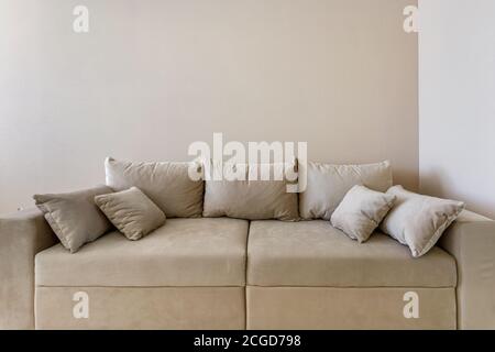 fabric sofa with pillows in Interior of modern guestroom in studio apartments Stock Photo