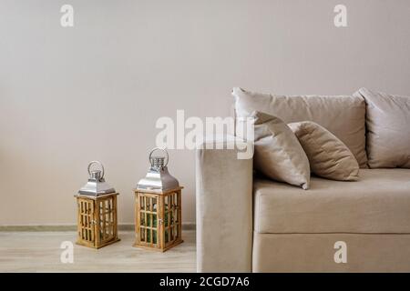 fabric sofa with pillows and lanterns in Interior of modern guestroom in studio apartments Stock Photo