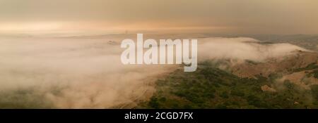 A layer of thick smoke, generated by many wildfires throughout California, darkens the sky above the marine layer over the San Francisco Bay Area. Stock Photo