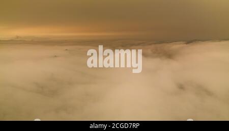 A layer of thick smoke, generated by many wildfires throughout California, darkens the sky above the marine layer over the San Francisco Bay Area. Stock Photo