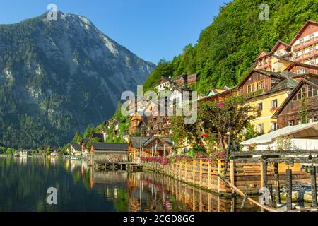 Classic postcard view of famous Hallstatt lakeside town, Austria. Scenic panoramic view of beautiful town reflecting in Hallstatter See.Beautiful sunn Stock Photo