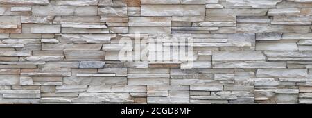 Stone background walls are stacked. Stone cladding background and wallpaper. Stock Photo