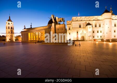 Night view of illuminated Cathedral Square in the Old Town of Vilnius, Lithuania. Cathedral Basilica of St Stanislaus and St Ladislaus on the left, mo