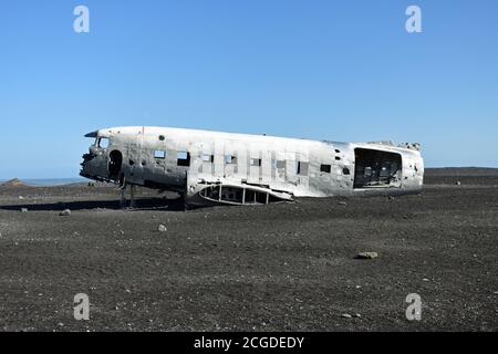 The fuselage of the Solheimasandur Plane Wreck sits on the black sand glacial outwash plains of Myrdalsjokull along the ring road in south Iceland. Stock Photo