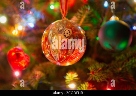 Christmas ornaments hanging in an illuminated balsam fir Christmas tree. Stock Photo