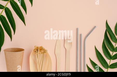 Eco cutlery and metal drinking straws on pink background. Zero waste concept. Stock Photo
