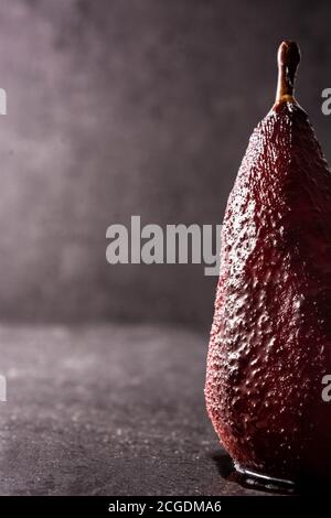 Poached pears in red wine on black background Stock Photo