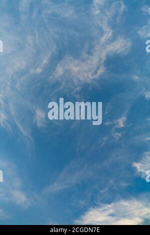 wispy white clouds in a blue sky Stock Photo