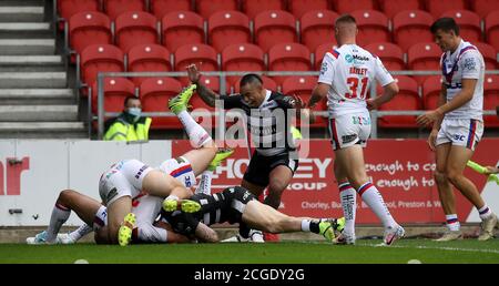 Hull FC's Adam Swift dives in to score a try during the Betfred Super League match at The Totally Wicked Stadium, St Helens. Stock Photo