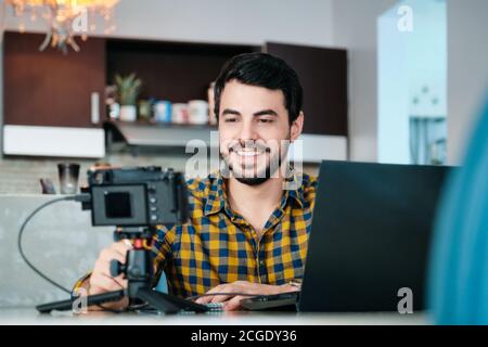 Young Man Working From Home Making Business Web Conference Stock Photo