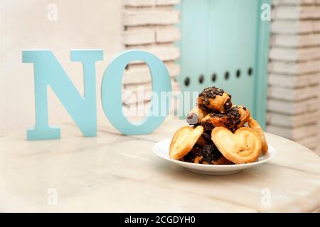 Cup of coffee, coffee beans, with plate of sweets on marble table, top view Stock Photo