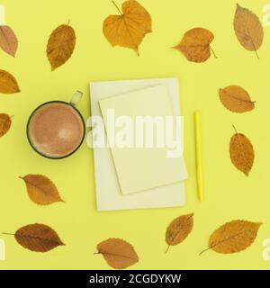 Autumn composition in yellow shades. Flat lay notepad, coffee and autumn dry leaves. To do list Mock up Top view Stock Photo