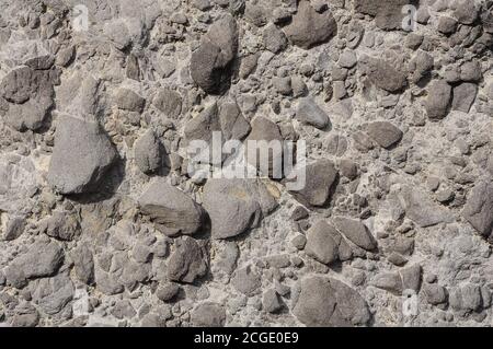 Grey volcanic rocks texture with basalt, geological formation Stock Photo
