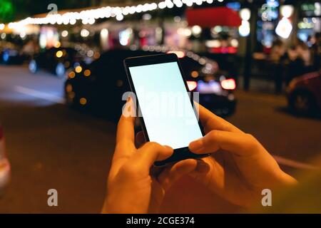 Mobile phone in female hands at night Stock Photo