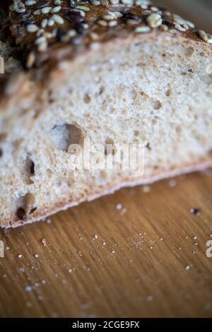 Freshly baked seeded loaf on a bread board Stock Photo
