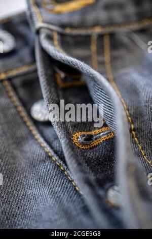 Close-up of a button fly on a pair of black jeans Stock Photo
