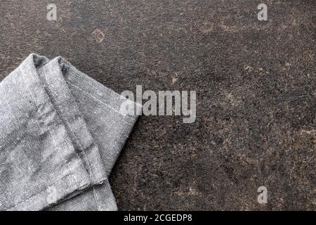Kitchen towel on black table. Napkin on black background. Top view. Stock Photo