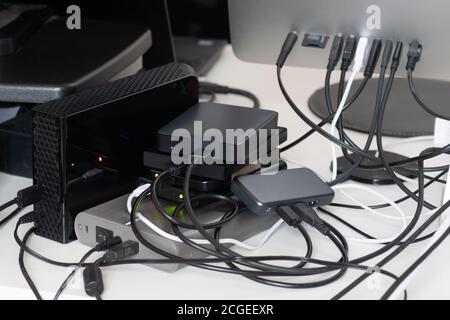 USB hard drives plugged into computer to expand storage space. Direct attached storage. Peripherals, hub, backup, disks, expansion, DAS, data Stock Photo