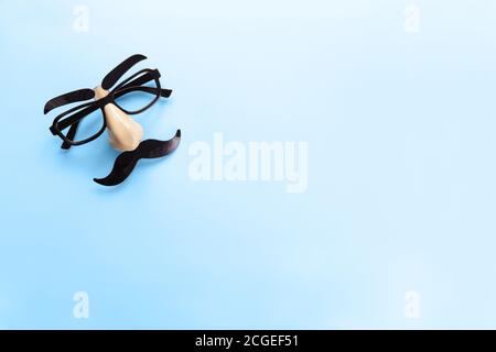 Carnival mask with moustache, nose and glasses on blue background, copy space. Concept men's health, prostate cancer awareness month, charity, Father' Stock Photo