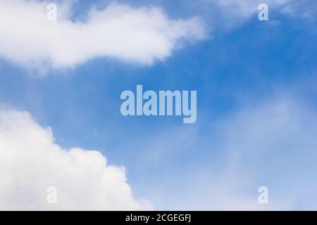 Beautiful white fluffy clouds on a blue sky background, copy space Stock Photo
