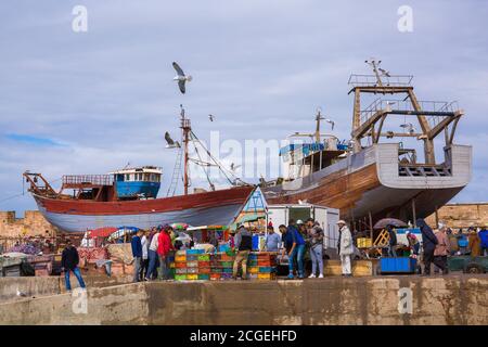 Men working on the waterfront in Essaoiura, Morocco Stock Photo