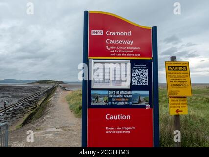 Cramond causeway noticeboard with tide time information, Cramond, Scotland. Stock Photo