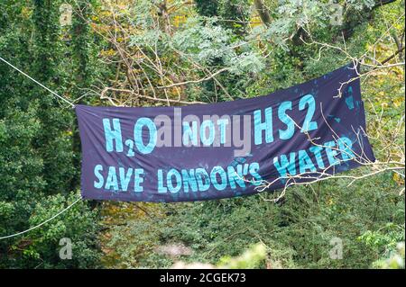 Denham, Buckinghamshire, UK. 8th September, 2020. An H2O not HS2 Save London's Water banner.  Anti HS2 Environmental Activists are concerned about HS2 pile driving into the chalk acquifier and risking contamination into the water that supplies London. The controversial HS2 High Speed Rail link is set to damage or destroy 108 ancient woodlands. Credit: Maureen McLean/Alamy Stock Photo