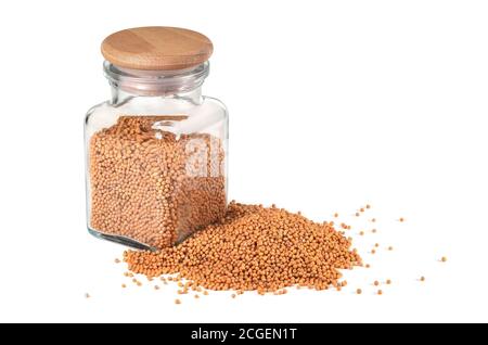 Spice, mustard. Mustard seeds, in a jar for spices on a white background. Isolated, closeup. Stock Photo