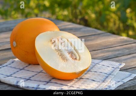 Yellow ripe melon on wooden table, close-up Stock Photo