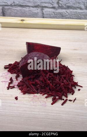 grate beetroot on a grater, fresh beet grated Stock Photo