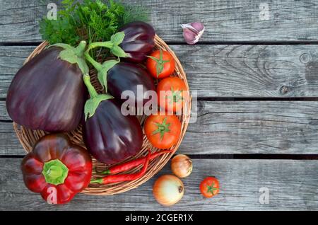 Fresh summer vegetables on a old wooden table. Close-up, top view Stock Photo