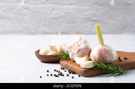 Fresh garlic, herbs and spices on a marble table with copy space Stock Photo