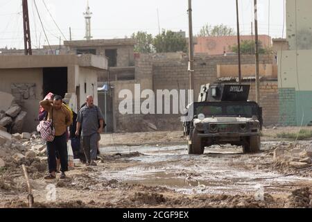 IDPs flee from war in Al Bakir district of East Mosul, Iraq. Taken during the early days of the Mosul Operation 2016-2017. Stock Photo