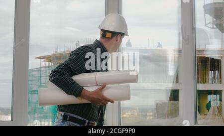 Engineer checking construction through the window. Stock Photo