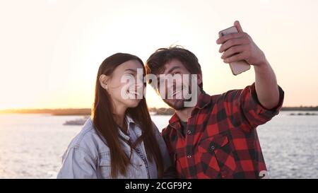Couple in love taking selfies outdoors. Stock Photo
