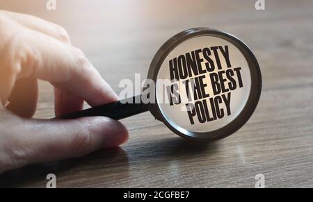 Honesty Is The Best Policy Messageunder magnifying glass in hand. Marketing business concept