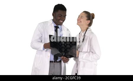 Laughing doctors studying X-ray on white background. Stock Photo