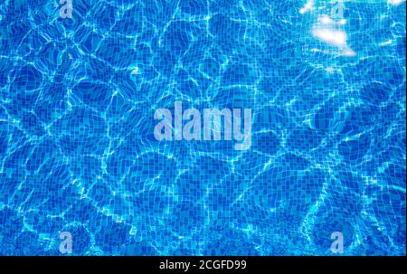 Background texture surface of blue swimming pool of water with refractive sun Stock Photo
