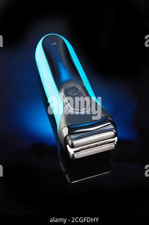 Shaving machine on a black background with blue. Selective focus Stock Photo