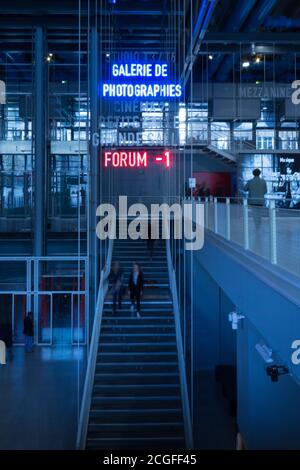 The Pompidou Center in Paris. Main floor, an indoor shot of people walking around.  Photography Gallery and cinema in background. Stock Photo