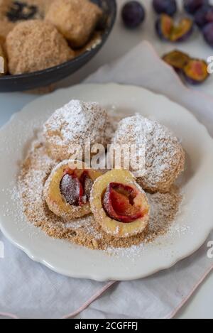 Typical Austrian plum dumplings made of leavened dough and fresh plums Stock Photo