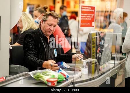 Potsdam, Germany. 10th Sep, 2020. Claudius Dreilich (Karat) is committed to helping socially disadvantaged people. For the campaign 'Deutschland rundet auf' the band members sit at the cash desk and collect money in the Kaufland of Potsdam's main station. Credit: Gerald Matzka/dpa-Zentralbild/ZB/dpa/Alamy Live News Stock Photo