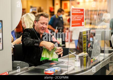 Potsdam, Germany. 10th Sep, 2020. Claudius Dreilich (Karat) is committed to helping socially disadvantaged people. For the campaign 'Deutschland rundet auf' the band members sit at the cash desk and collect money in the Kaufland of Potsdam's main station. Credit: Gerald Matzka/dpa-Zentralbild/ZB/dpa/Alamy Live News Stock Photo