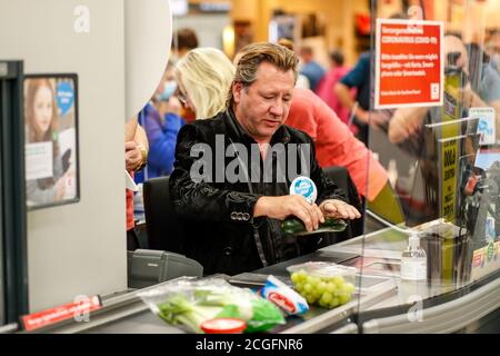 Potsdam, Germany. 10th Sep, 2020. Claudius Dreilich (Karat) is committed to helping socially disadvantaged people. For the campaign 'Deutschland rundet auf' the band members sit at the cash desk and collect money in the Kaufland of Potsdam's main station. Credit: Gerald Matzka/dpa-Zentralbild/ZB/dpa/Alamy Live News Stock Photo